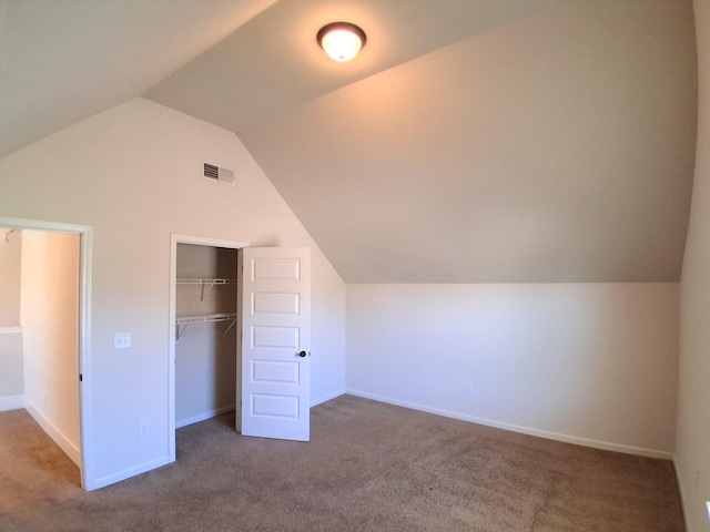 additional living space featuring lofted ceiling, carpet, visible vents, and baseboards