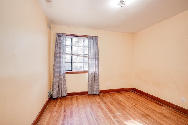 unfurnished room with visible vents, baseboards, and light wood-style floors