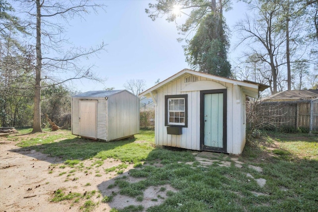 view of shed featuring fence