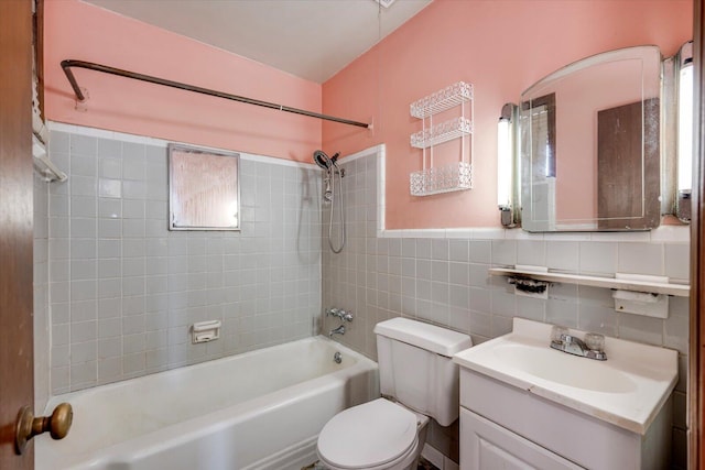 bathroom with bathing tub / shower combination, tile walls, vanity, and toilet