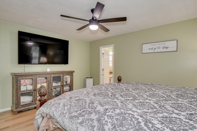 bedroom featuring light wood-style flooring and a ceiling fan