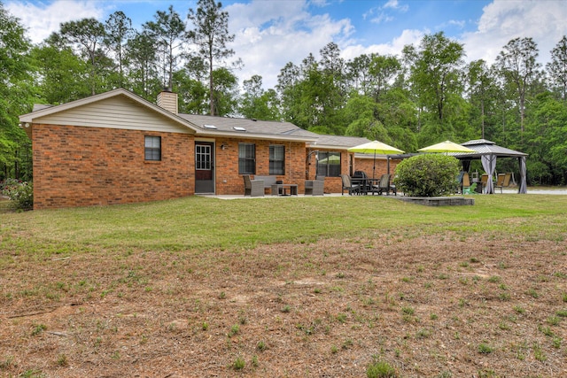 1457 Brown Rd, Hephzibah, GA 30815 - rear view of house featuring a gazebo, a patio area, brick siding, and a chimney
