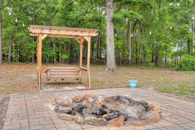 view of patio / terrace featuring an outdoor fire pit