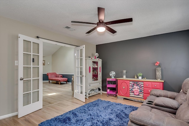 1457 Brown Rd, Hephzibah, GA 30815 - living area featuring french doors, ceiling fan, wood finished floors, a textured ceiling, and baseboards