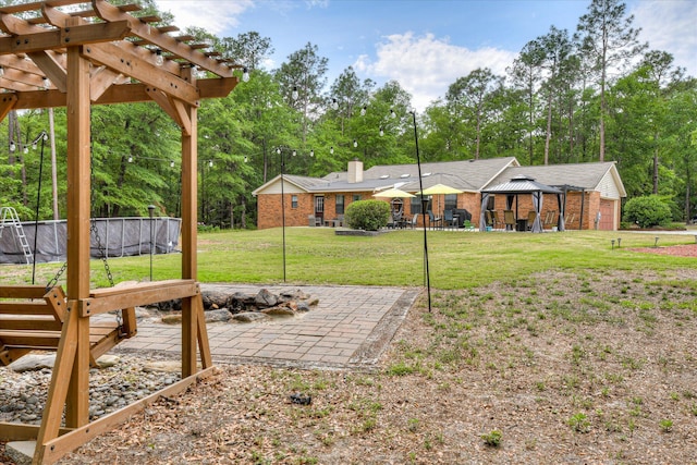 1457 Brown Rd, Hephzibah, GA 30815 - view of grassy yard featuring a patio, a pergola, and view of wooded area