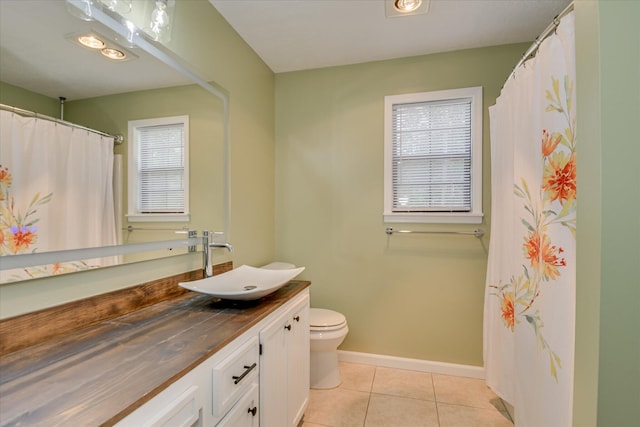 bathroom with tile patterned floors, baseboards, vanity, and toilet