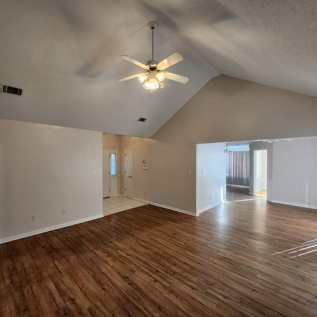 unfurnished living room with light wood-type flooring, vaulted ceiling, and ceiling fan