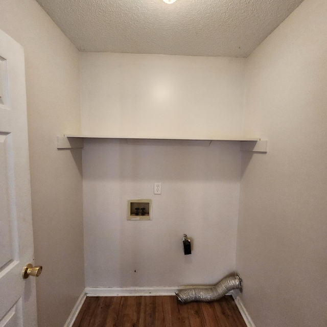 clothes washing area with a textured ceiling, hookup for an electric dryer, dark wood-type flooring, and hookup for a washing machine