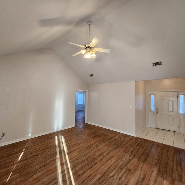 interior space with ceiling fan, lofted ceiling, and light wood-type flooring