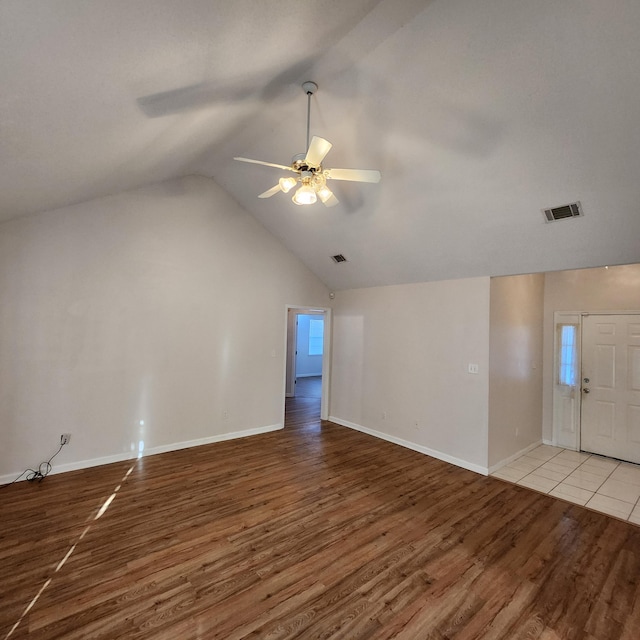 unfurnished living room featuring light wood-type flooring, vaulted ceiling, and ceiling fan