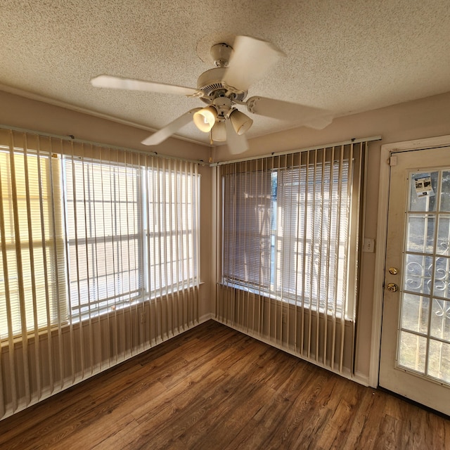 unfurnished sunroom with ceiling fan