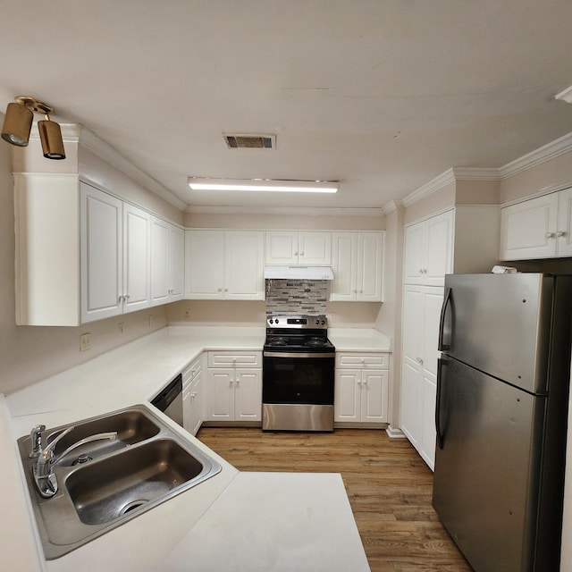 kitchen with sink, white cabinetry, stainless steel appliances, and light wood-type flooring