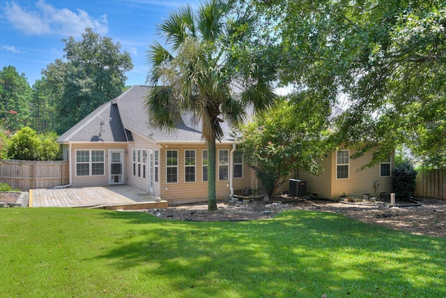 back of house with a wooden deck, a yard, and cooling unit