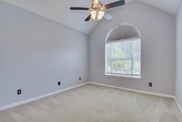 carpeted spare room featuring ceiling fan and lofted ceiling