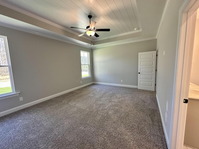 unfurnished room with carpet flooring, wood ceiling, a tray ceiling, ceiling fan, and crown molding