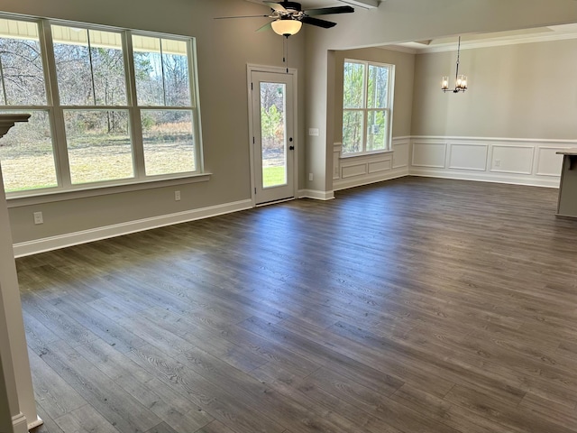 unfurnished room featuring ornamental molding, ceiling fan with notable chandelier, dark wood-type flooring, and beam ceiling