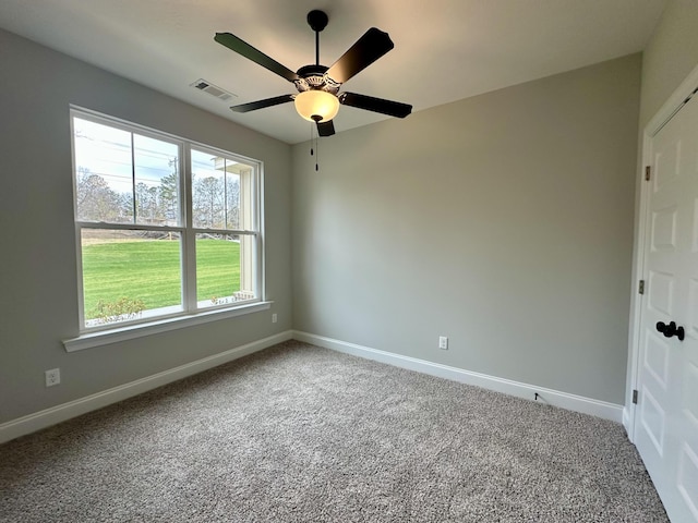 carpeted empty room featuring ceiling fan