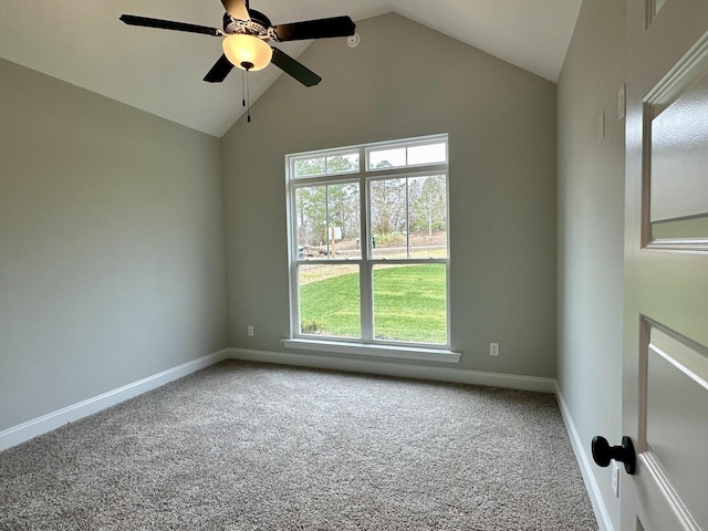 carpeted spare room with ceiling fan and vaulted ceiling