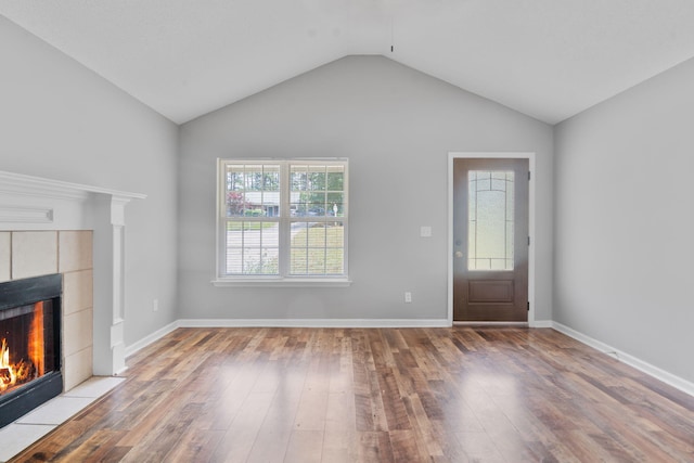 3363 Saddlebrook Dr, Hephzibah, GA 30815 - unfurnished living room featuring hardwood / wood-style floors, a fireplace, lofted ceiling, and baseboards