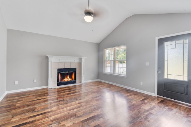 3363 Saddlebrook Dr, Hephzibah, GA 30815 - unfurnished living room featuring wood finished floors, vaulted ceiling, a tile fireplace, a ceiling fan, and baseboards