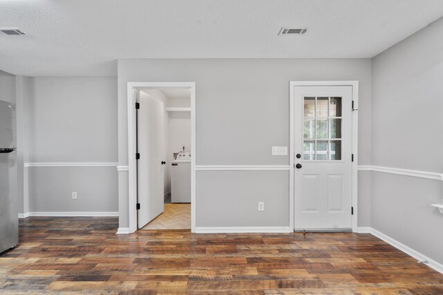 3363 Saddlebrook Dr, Hephzibah, GA 30815 - entrance foyer featuring washer / clothes dryer, wood finished floors, baseboards, and a textured ceiling