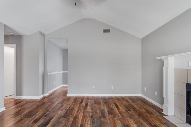 3363 Saddlebrook Dr, Hephzibah, GA 30815 - unfurnished living room with a tiled fireplace, lofted ceiling, wood finished floors, and baseboards