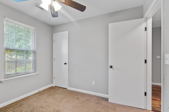 3363 Saddlebrook Dr, Hephzibah, GA 30815 - unfurnished bedroom with multiple windows, carpet, baseboards, and ceiling fan