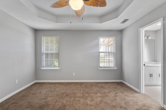 3363 Saddlebrook Dr, Hephzibah, GA 30815 - unfurnished bedroom featuring carpet flooring, a tray ceiling, and baseboards