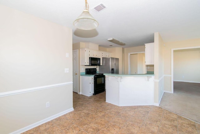 kitchen featuring white cabinets, hanging light fixtures, and black appliances