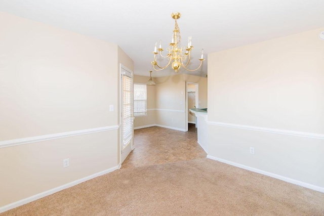 empty room featuring light carpet and a notable chandelier