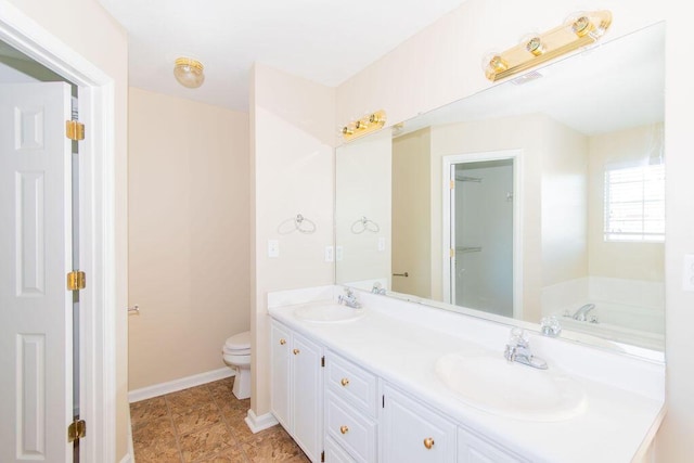 bathroom with a bathing tub, vanity, and toilet