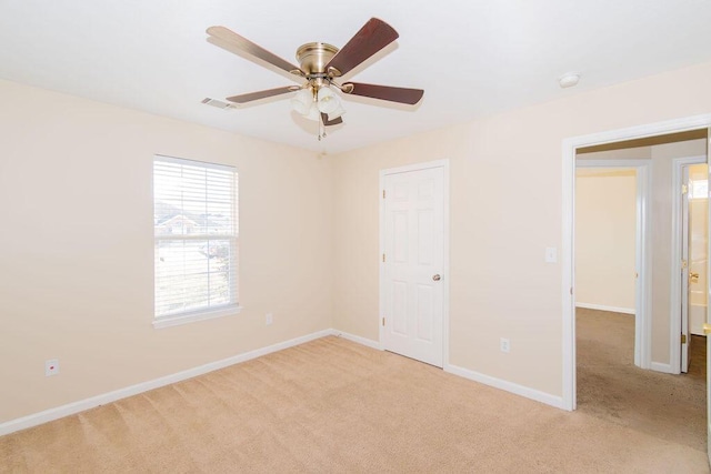 unfurnished bedroom with light carpet and ceiling fan