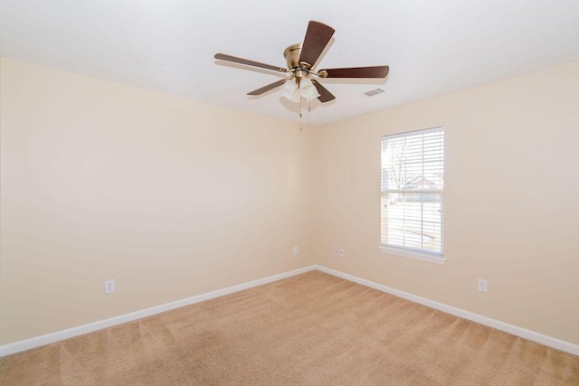 unfurnished room featuring light colored carpet and ceiling fan