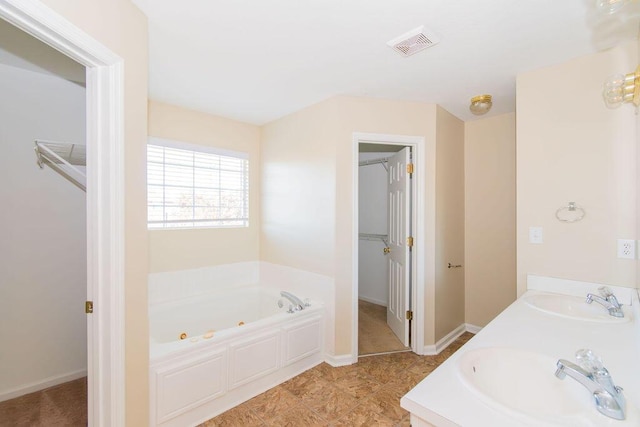 bathroom with vanity and a tub