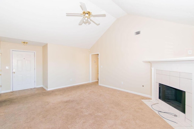 unfurnished living room with a tile fireplace, light carpet, ceiling fan, and lofted ceiling