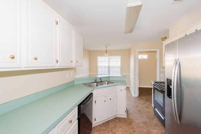 kitchen with sink, kitchen peninsula, appliances with stainless steel finishes, decorative light fixtures, and white cabinetry