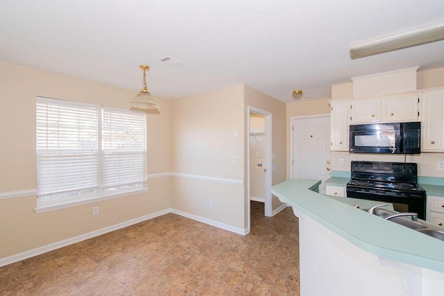 kitchen with sink, white cabinets, black appliances, and decorative light fixtures