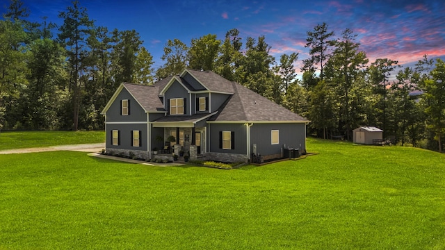 view of front facade with a storage shed and a lawn