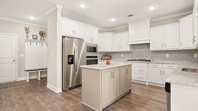 kitchen featuring white cabinetry, stainless steel appliances, tasteful backsplash, a kitchen island, and custom exhaust hood