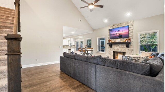 living room featuring ceiling fan, a fireplace, high vaulted ceiling, and dark hardwood / wood-style floors