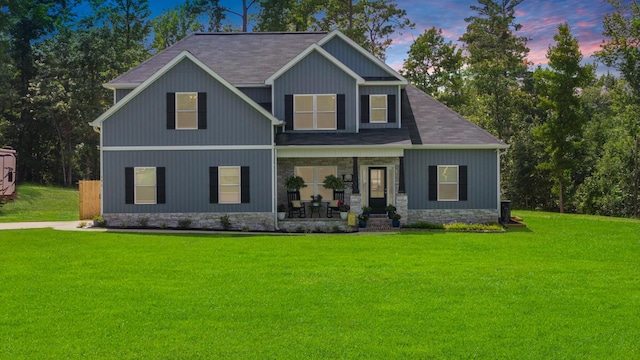 craftsman house with a lawn and a porch