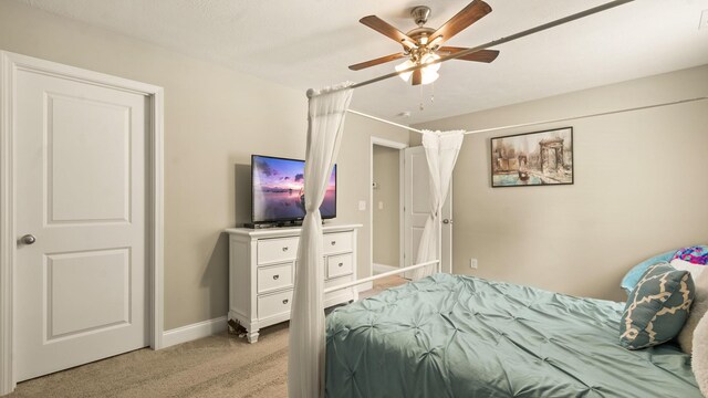 bedroom featuring light carpet and ceiling fan