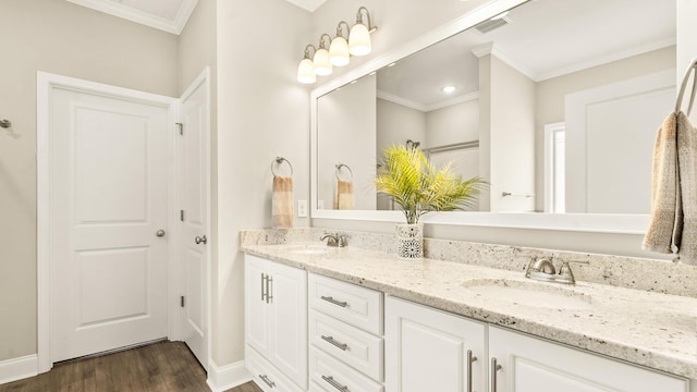 bathroom featuring vanity, hardwood / wood-style flooring, and crown molding