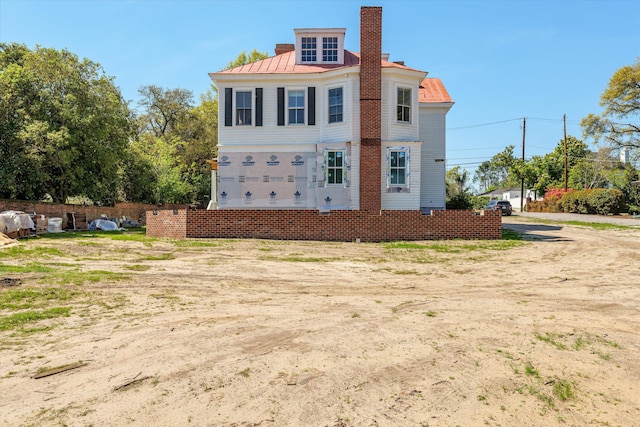 946 Milledge Rd, Augusta, GA 30904 - view of front of house featuring a chimney, a metal roof, and a standing seam roof