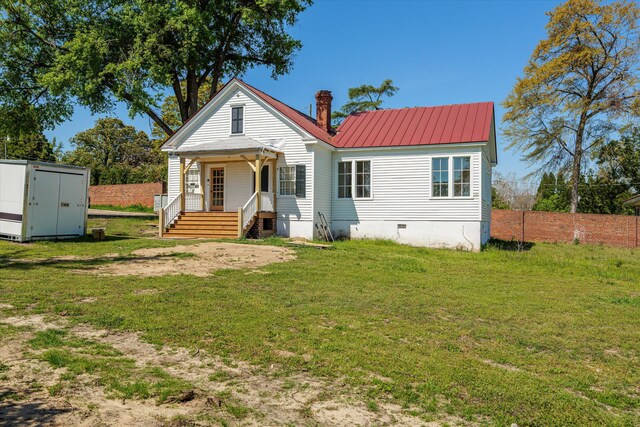 946 Milledge Rd, Augusta, GA 30904 - rear view of property featuring a porch, a chimney, a yard, and a storage shed