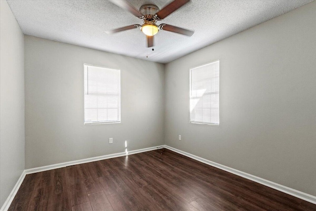 unfurnished room with dark wood-type flooring, ceiling fan, plenty of natural light, and a textured ceiling