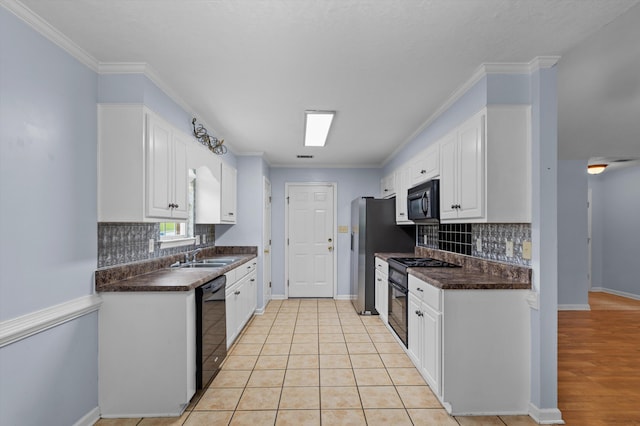 3007 Ashland Way, Grovetown, GA 30813 - kitchen with black appliances, dark countertops, white cabinetry, a sink, and decorative backsplash