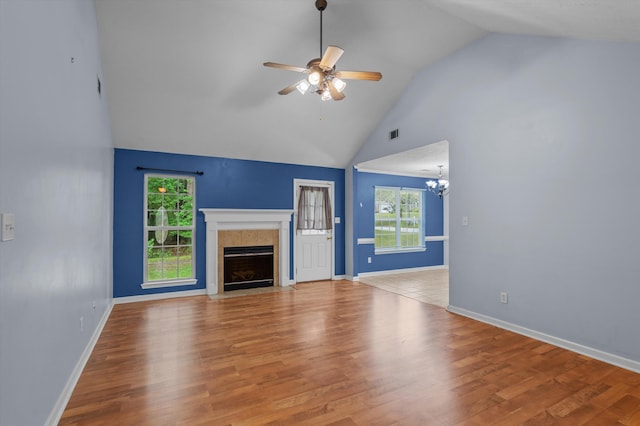 3007 Ashland Way, Grovetown, GA 30813 - unfurnished living room with ceiling fan, a tile fireplace, plenty of natural light, a chandelier, and high vaulted ceiling
