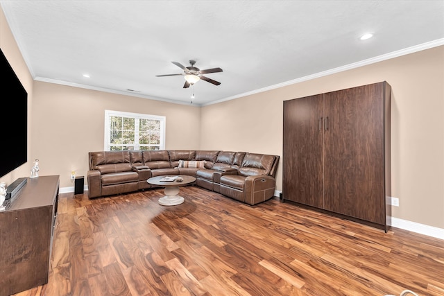 living room with crown molding, ceiling fan, and light hardwood / wood-style flooring