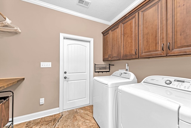 washroom featuring cabinets, ornamental molding, washing machine and dryer, and a textured ceiling